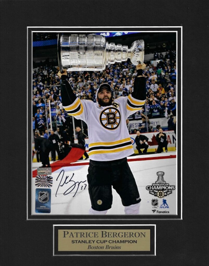 Patrice Bergeron Autograph Photo Holding Stanley Cup 2011 11×14 - Autographed NHL Photos